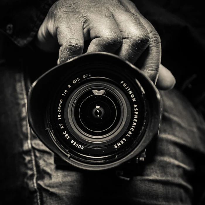 Close-up of a camera lens, held ready for the next shot